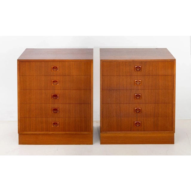 Pair of Danish Modern Teak Wood Chest of Drawers, each with five drawers and carved wood drawer pulls on rectangular...