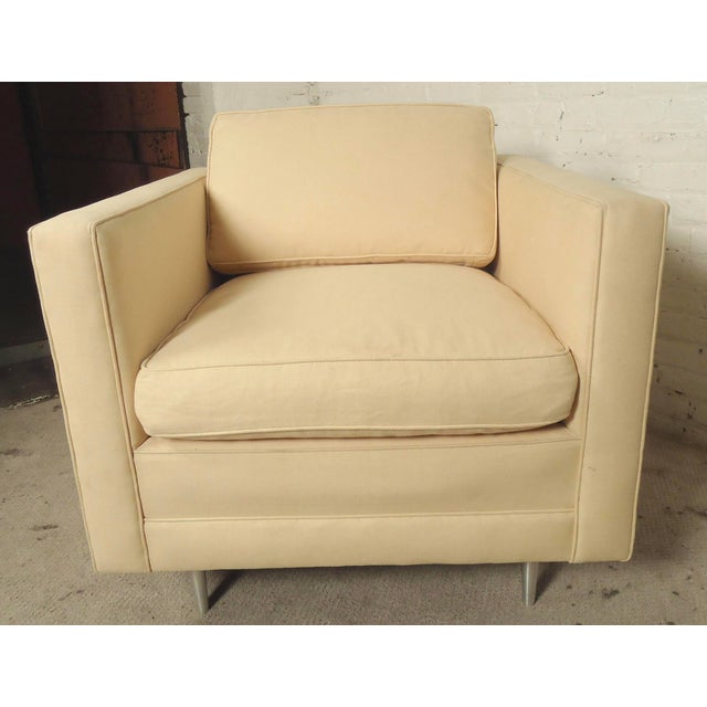 Square lounge chair with high arms and chrome feet. Large soft cushioning, beige upholstery. No maker's mark. (Please...