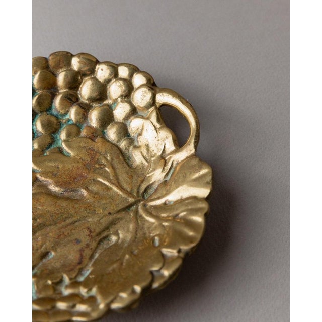 This vintage brass ashtray from Italy, designed in the 1960s, features an elegant grape structure that adds a touch of...