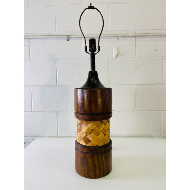 Vintage 1970s pine wood and rattan accented table lamp. Wired for the US and in working condition. Used standard size...