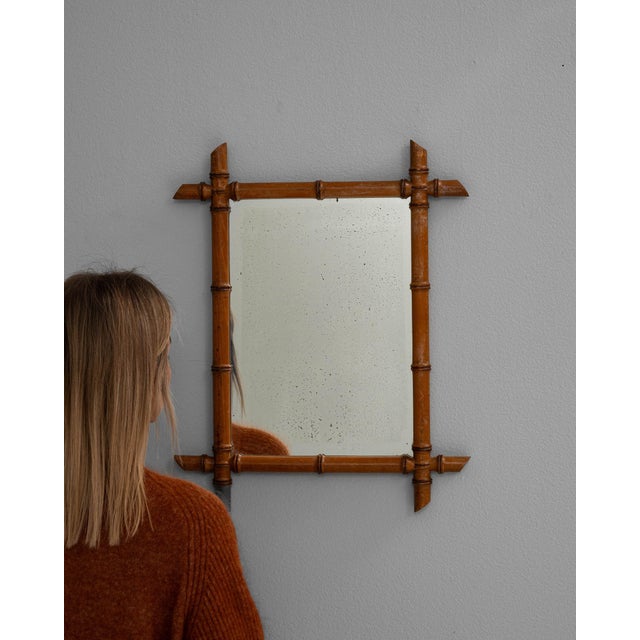 This piece presents as a mirror, distinguished by faux bamboo wood frame, natural brown. It was made in France during 19th...