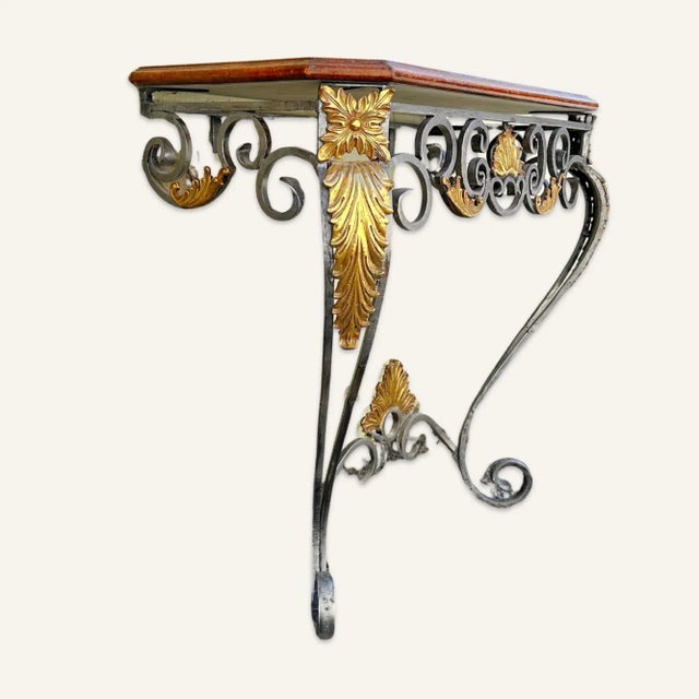 Heavy, graceful but sturdily built scrollwork wrought iron pier or wall table with brass acanthus leaf decoration on the...