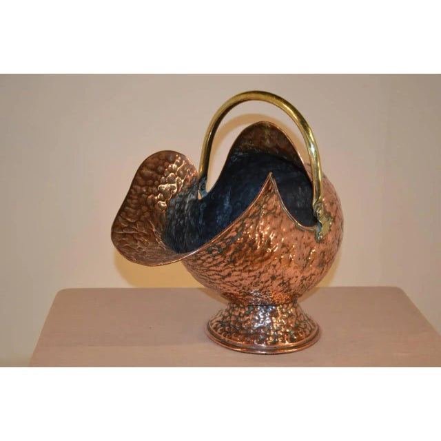 19th Century English coal hod made from hand-hammered copper. It has a fantastically Silhouetted shape and handmade brass...