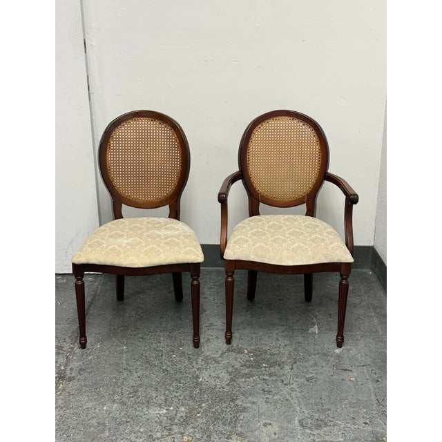 Design Plus Gallery presents a Pair of Traditional Oval Cane-Back Chairs from The Bombay Company. The set includes one...