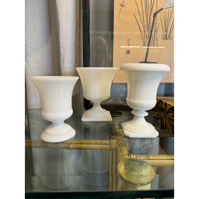 Collection of three vintage classic style milk glass coupes vases. Large:5.5”Diam x 7”H Med: 5” Diam. x 7”H Small:4.5”...