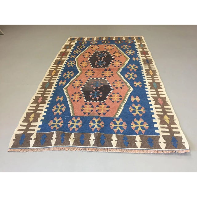 Old Turkish Kilim Rug. This is a lovely central Anatolian, Turkish kilim rug from 1960s with blues and pinks with a...
