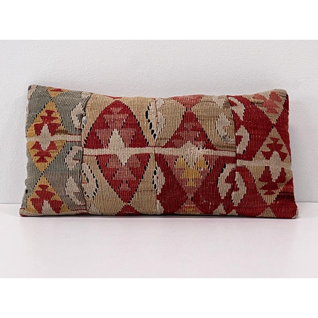 Handcrafted lumbar pillow made from a vintage handwoven Turkish kilim, featuring rich tones of burgundy, ivory, taupe,...