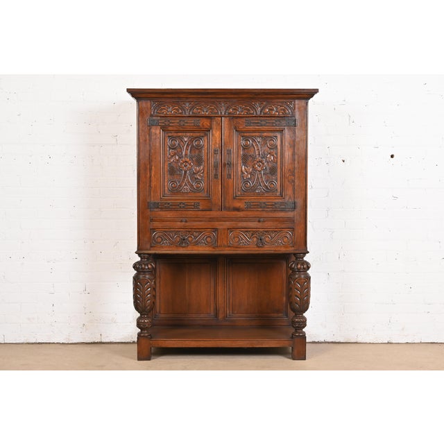 An exceptional English Jacobean, Victorian, or Renaissance Revival bar cabinet In the manner of R.J. Horner & Co. England,...