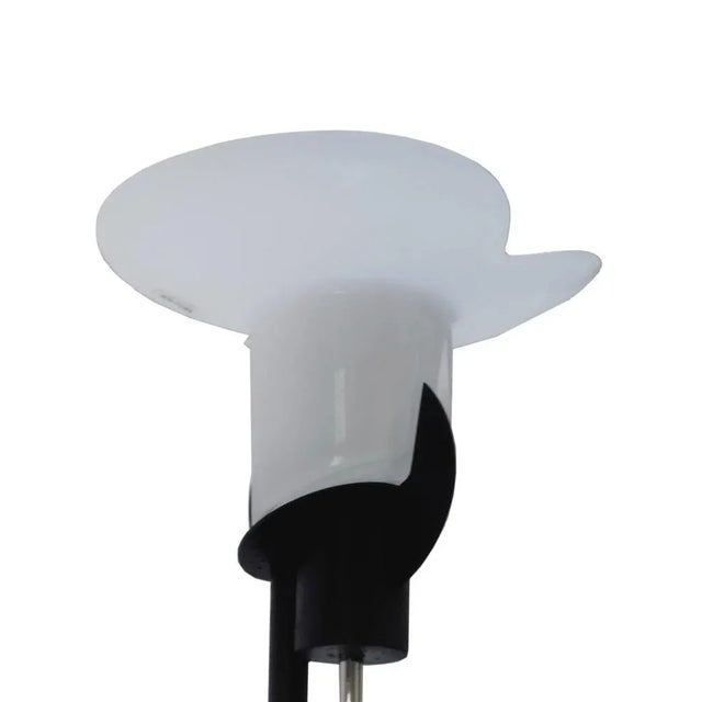 A rare, elegant and refined floor lamp in opaline white Murano glass and black lacquered metal frame, a classic example of...