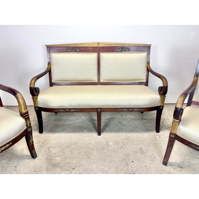 An exquisite French Empire / Directoire parlor set with bronze ormolu mounts, mahogany frames with gilt decoration and new...
