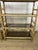 A pair of six-shelf bookcases with a bamboo frame, smoked glass shelves, and wicker details, made in Italy in the 1970s....