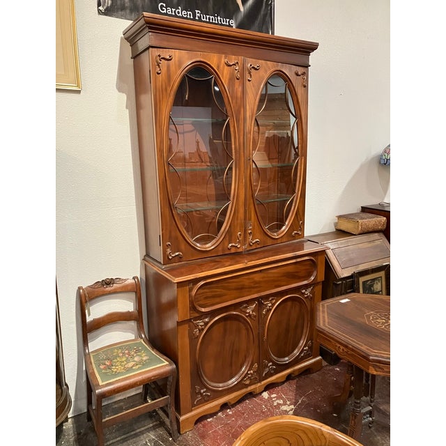 Antique Secretary Bookcase has a lovely dropdown cubby. Two-piece design for easy transport. Damage to the wood lace on...