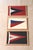 Vintage triangular yacht club burgees mounted on a contrasting ground and framed in new natural oak frames.