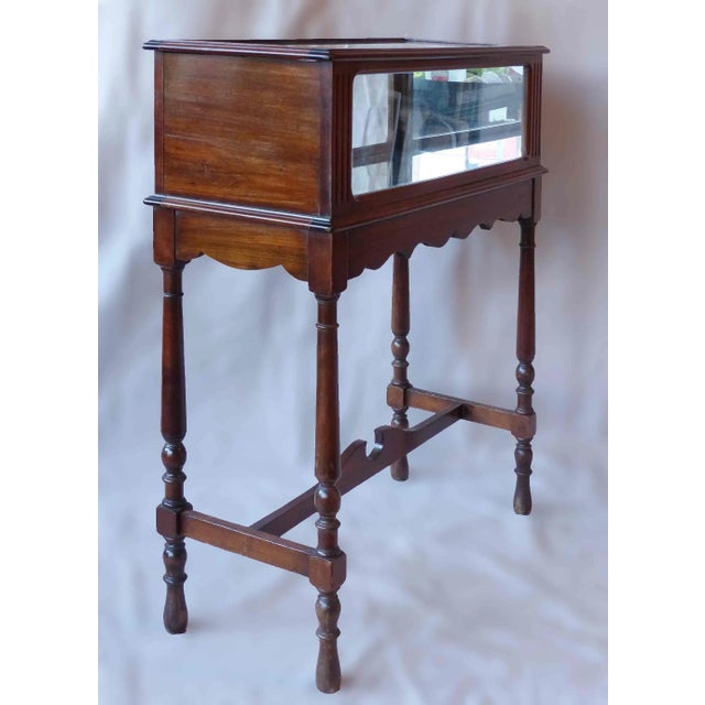 Early 20th century traditional oak and glass jewelry showcase. It case has hand carved features and opens on the top.