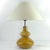 This table lamp was manufactured by Polam Piła in the 1970s. The base is made of glazed ceramic in a golden ochre color....