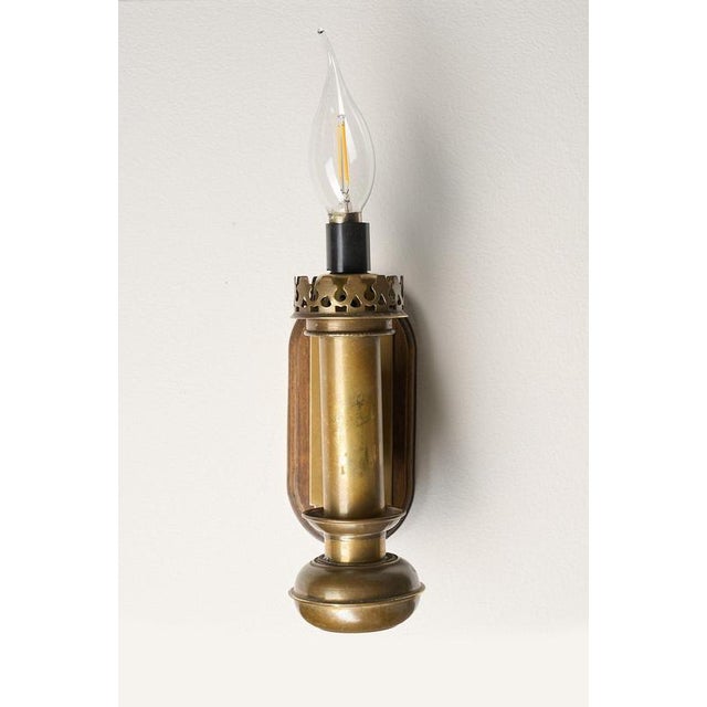 This pair of small wall sconces date from the mid-20th century and are designed in the classic traditional style. The...