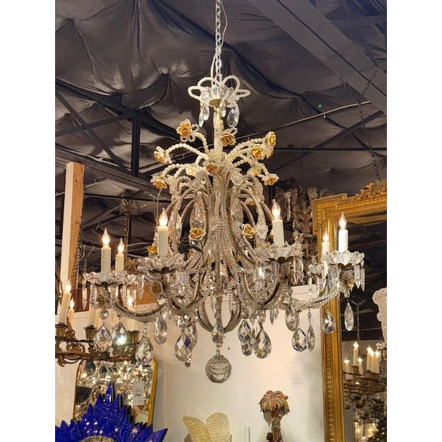 This 19th Century Italian chandelier features intricate beaded crystal and porcelain flowers, creating a stunning and...