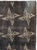 This mid-20th-century Turkish Anatolian rug presents a disciplined allover arrangement of star-like geometric motifs...