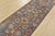 A tribal Caucasian Kazak runner hand-knotted with fine wool on a cotton foundation. This rug features a row of geometric...