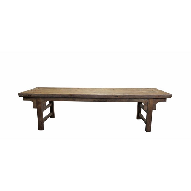 This antique Chinese elm bench showcases a blend of traditional craftsmanship with its classic inset flush top and...