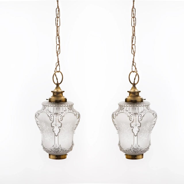 A Pair of pectacular 1950s French Rococo Style Brass Chain Pendant Lights with Heavy Acid-Etched Pressed Crystal Shades....