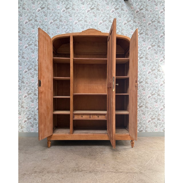 A stunning art deco wardrobe from the 1930s, whose gracefully curved silhouette, magnificent speckled maple veneer, and...