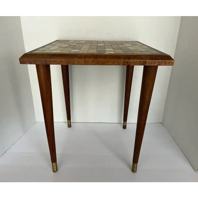 This vintage 1960s side table features a mosaic tile top set into a square walnut frame. All mosaic tiles in place,...