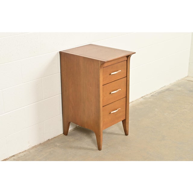 A sleek and stylish Mid-Century Modern three-drawer nightstand or bachelor chest By John Van Koert for Drexel, "Profile"...