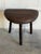 A three legs stool featuring a cushioned top paired with turned wooden support posts. Its organic tripod silhouette brings...