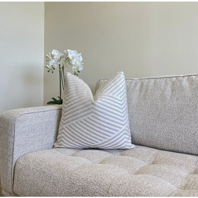 The cream velvet stripes in this geometric pattern over a beige background gives this pillow a striking contemporary look....