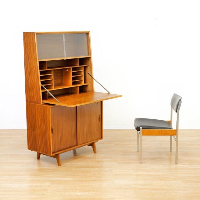This Mid-century secretary desk by Herbert. E Gibbs was produced in England during the 1960s. This stunning secretary desk...