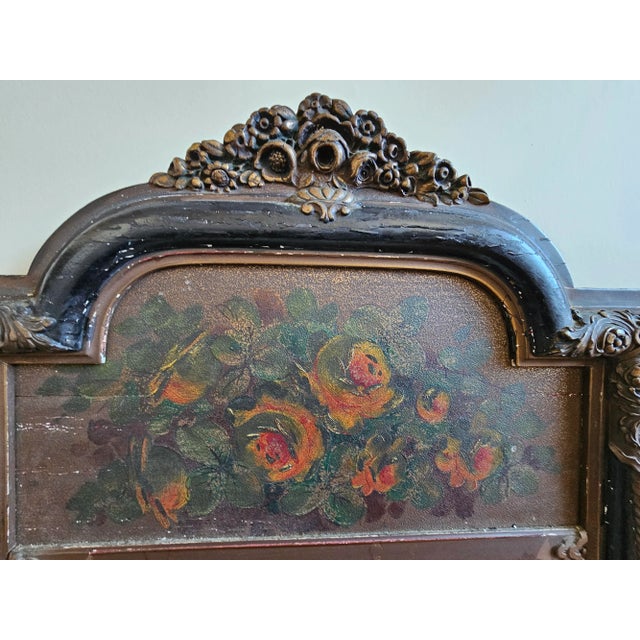 A 19th Century Louis Philippe Style Partial Gilt, Ebonized and Board Painted Trumeau Mirror . Measures 22" in width and...