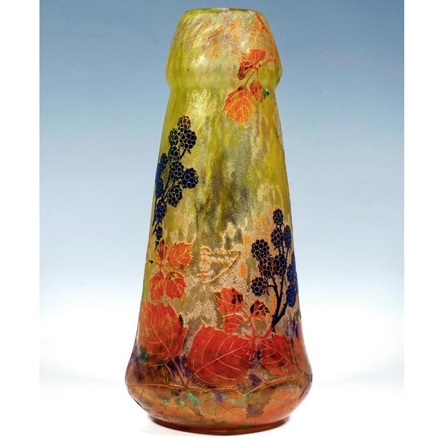 Conical vase, slightly bulbous at the base on a flush foot, tapering slightly as it curves upwards, opening out again into...