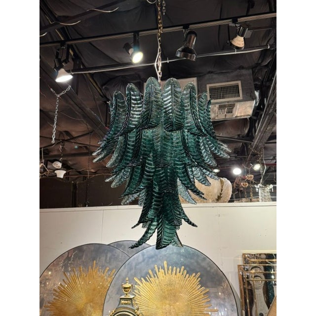 The Murano Deep Green Palm Leaf Chandelier is a stunning ceiling fixture that adds a touch of elegance and sophistication...