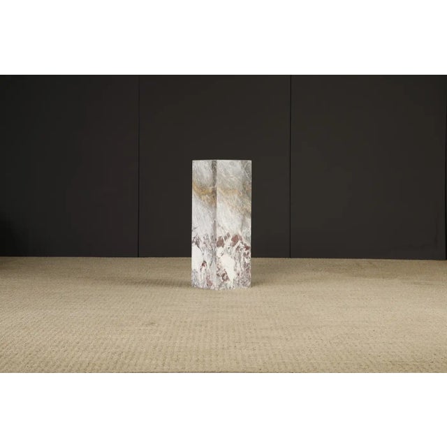 This beautiful 1980s Post-Modern exotic marble column pedestal features exotic graining and coloration with hues of grey,...