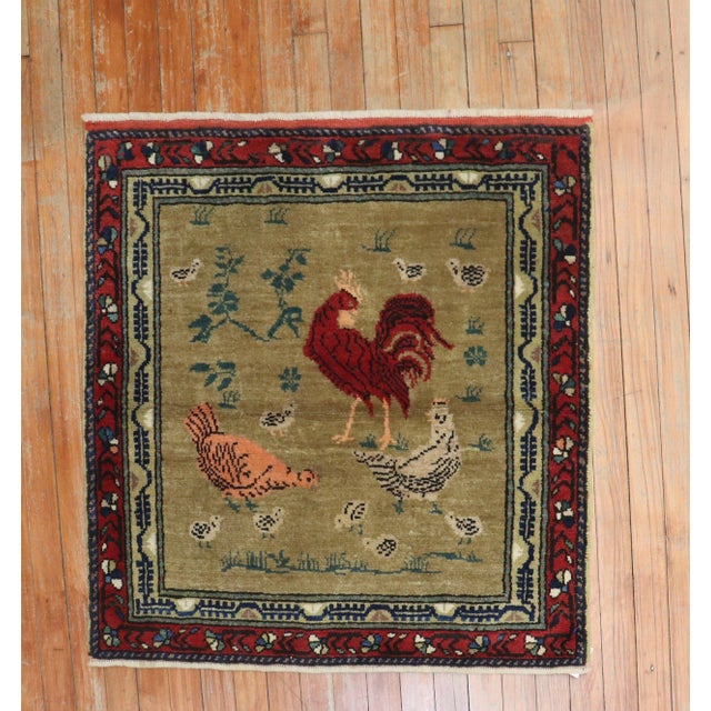 mid 20th century turkish rug depicting a chicken and rooster on a brown field Measures: 2'10" x 2'10''.