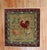 mid 20th century turkish rug depicting a chicken and rooster on a brown field Measures: 2'10" x 2'10''.