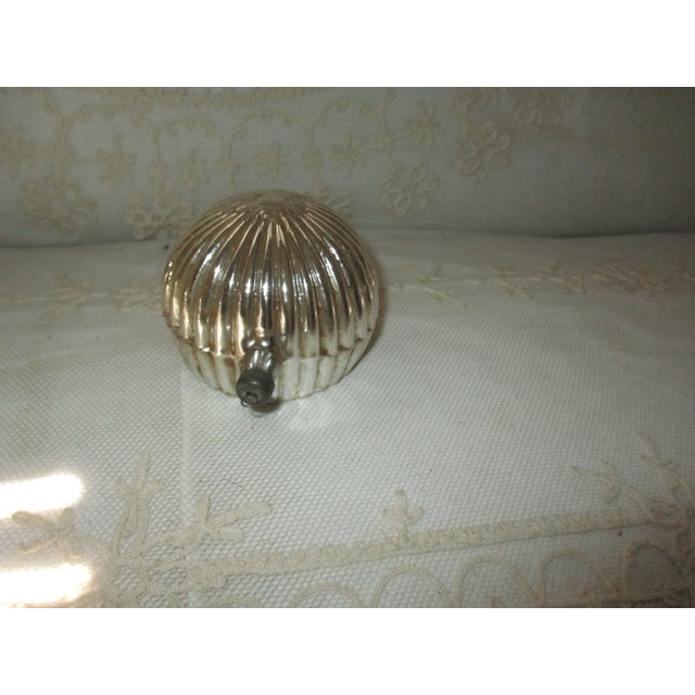 This is a Beautiful blown glass Ornament that features Yellow Color with a Paper Foil Star, unique Ribbed Back pattern,...