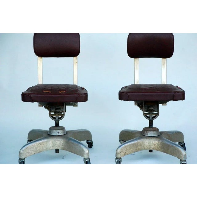 Pair of Aged Industrial Office Swivel Chairs. Please note the wear and tear on the seats.