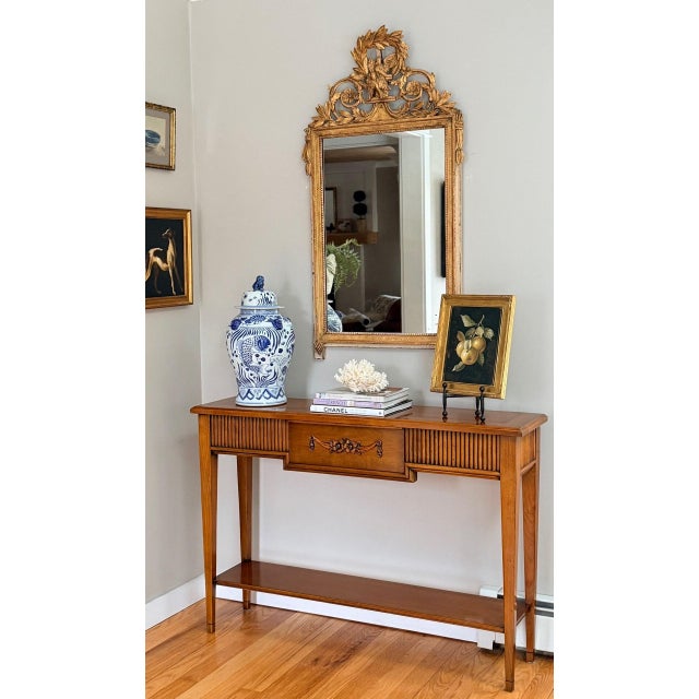 A beautifully proportioned Italian (Pregno), Mid-Century console table in a warm honey-toned wood, likely walnut or...