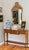 A beautifully proportioned Italian (Pregno), Mid-Century console table in a warm honey-toned wood, likely walnut or...