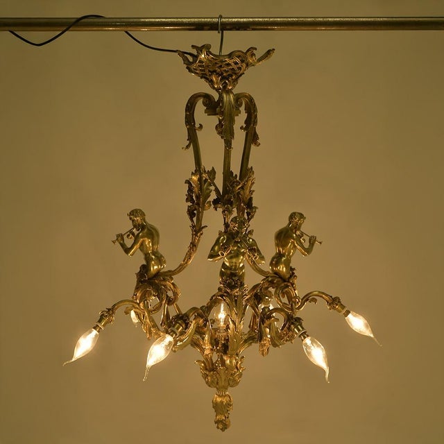 This spectacular gilt bronze chandelier, signed Mottheau, embodies all the richness of the French Rococo style. Adorned...