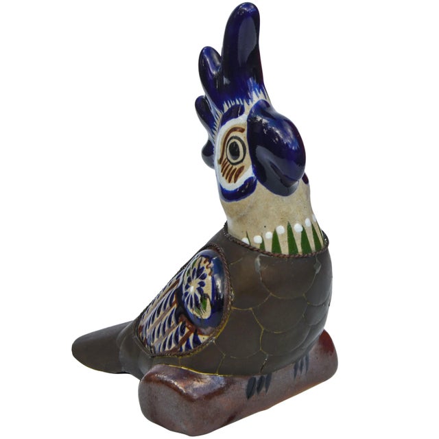 Vintage handcrafted ceramic parrot featuring an intricate hand-painted design with ornate brass inlay. No maker's mark....