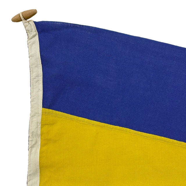 This vintage nautical flag is made from a cotton cloth in bold colors. Please note minor wear from age, with good...