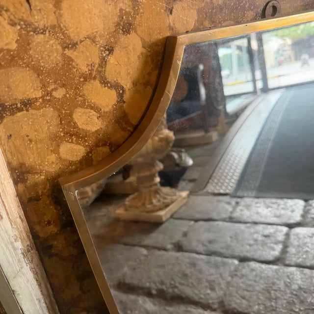 This elegant Italian wall mirror captures the sophisticated essence of 1950s Mid-Century Modern design, heavily inspired...