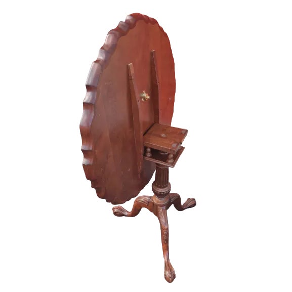 A large 32" Chippendale style mahogany tilt-top occasional or tea table with scalloped edge top. Table stands 28.5" in...