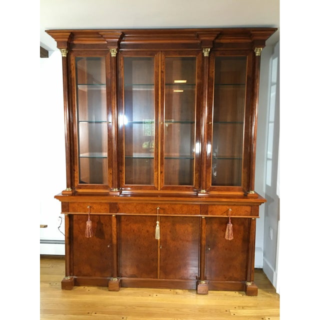 French Empire Style Custom Breakfront With Classical Brass Mounted Ormolu Columns A breathtaking vintage, two-piece burl...