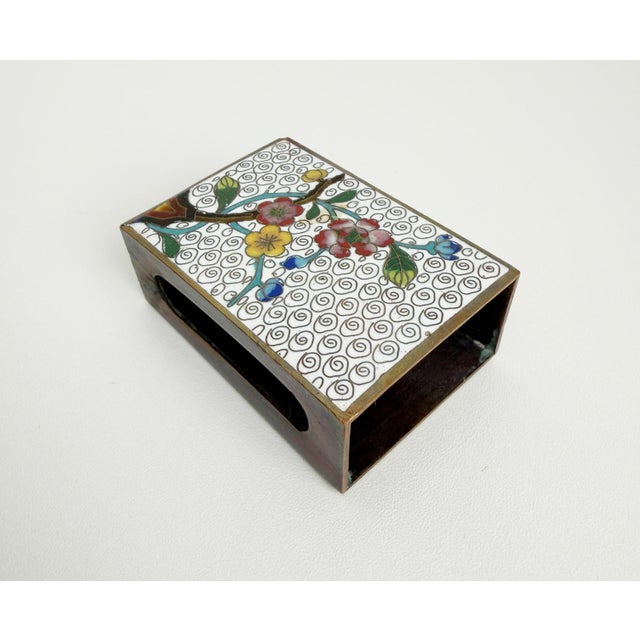 A lovely set of traditional Chinese cloisonne enamel on brass pieces featuring a cigarette box and a matching matchbook...