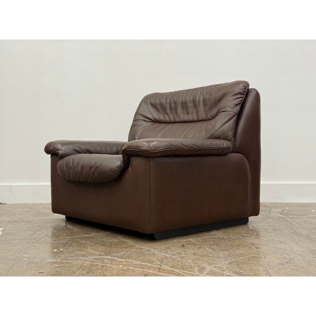 Vintage De sede model ds 63 lounge chair in patinated chocolate brown leather, Switzerland circa 1970s. This De Sede...