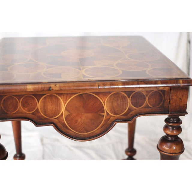 An entry or side table made by Theodore Alexander. Made with many contrasting pieces of oyster veneer in the William and...